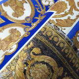 Close up of the roll of the Versace Home wallpaper 37048-1 pattern barocco blue